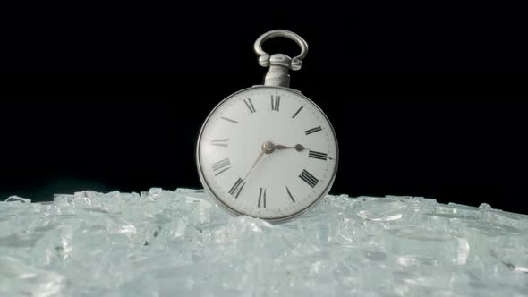 Antique Silver Pocket Watch Among Shiny Crystals or Sparkling Glass Splinters