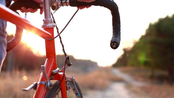 Girl on Bike with Sunset
