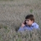 Teenage Boy Uses a Smartphone In Meadow - VideoHive Item for Sale