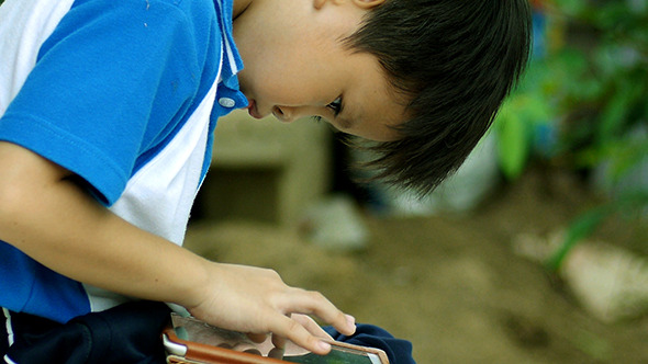 Young Boy Playing Video Game On The Tablet 01