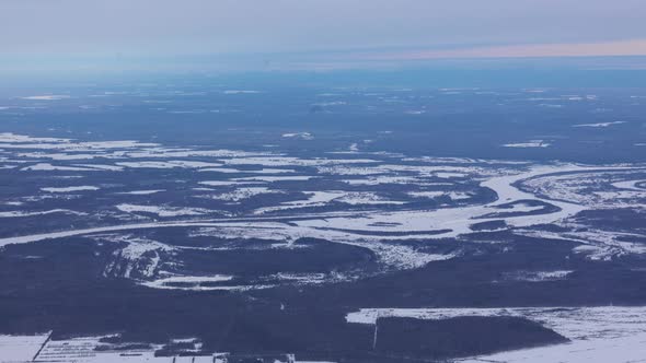 View of Winter Landscape of Earth From Window of Aircraft