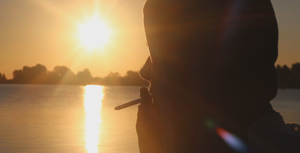 Man Smokes at Sunrise