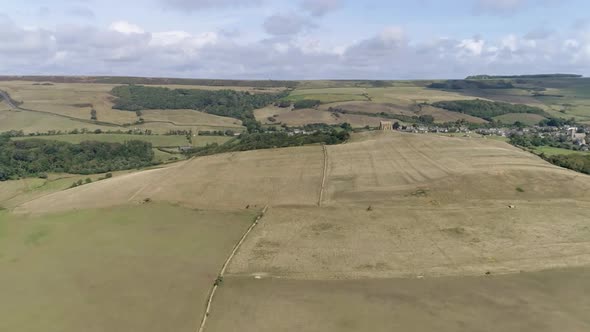 High aerial tracking forward towards the hilltop and the Chapel of St Catherine's near Abbotsbury, D