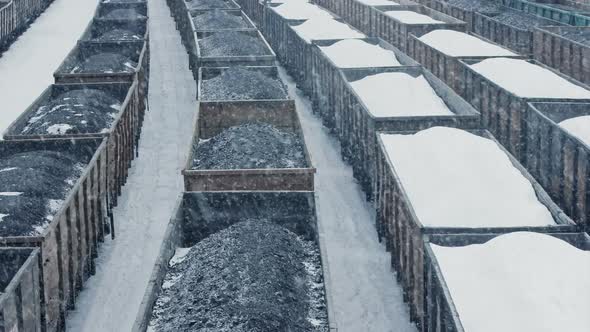 Train Yard With Coal Containers In Snowfall