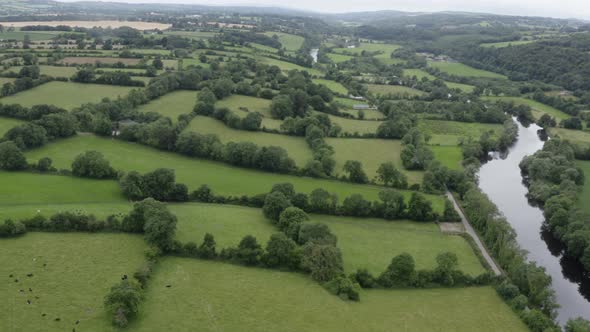 Lush green bucolic countryside pastures and small picturesque river