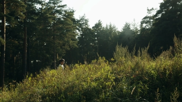 Little Boy Walking In The Forest