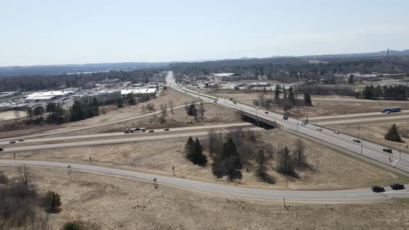 Overview of rural interstate highway interchange intersection in fall with dry grass and blue sky alt