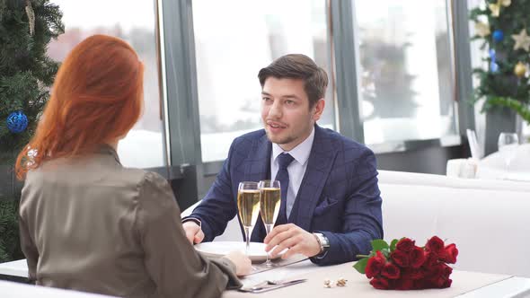 Young Caucasian Couple Celebrating Saint Valentines Day in Restaurant