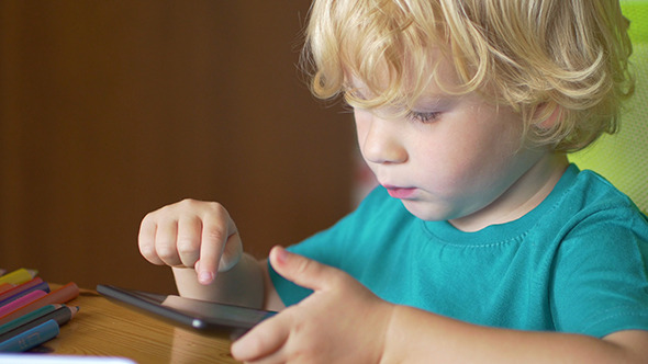 Little Boy Using A Digital Tablet