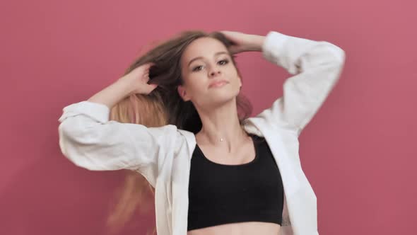 Young Woman Having Fun Smiling Dancing Shaking Hair While Listening to Music 