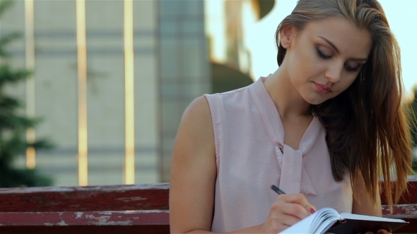 Young Attractive Girl Making Notes  alt