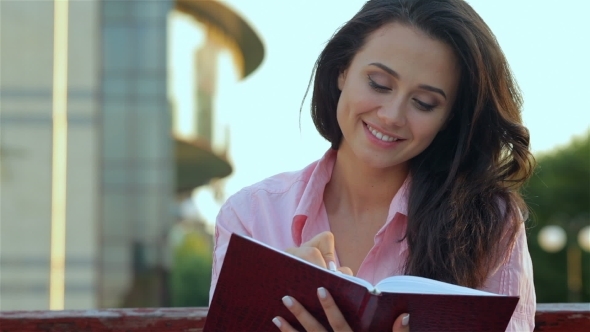 Young Beautiful Girl Making Notes  alt