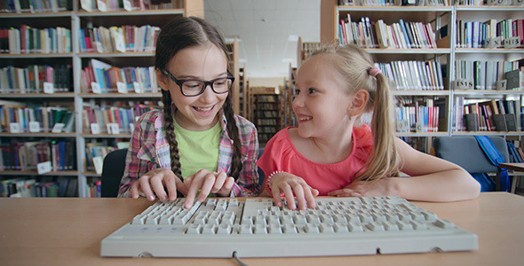 Cheerful Schoolgirls Typing 