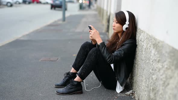 young asiatic woman listening music