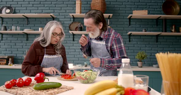 Senior Couple Cooking Healthy Food at House Kitchen