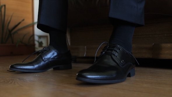 Groom Puts On Shoes And Tying Shoelaces