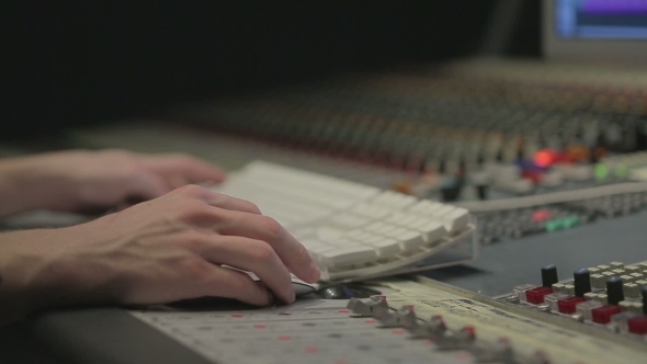 Audio Engineer Operating Mixing Console With Hands