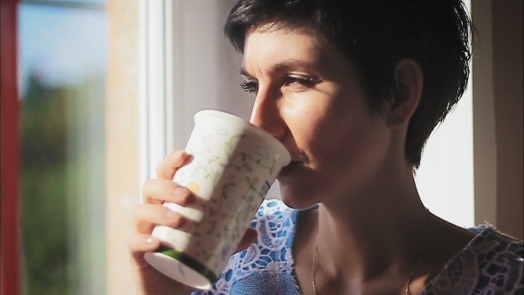 Beautiful Woman Sipping Hot Steaming Drink