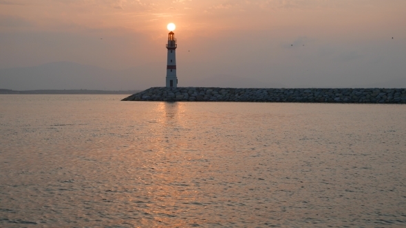 Lighthouse And Rising Sun Above
