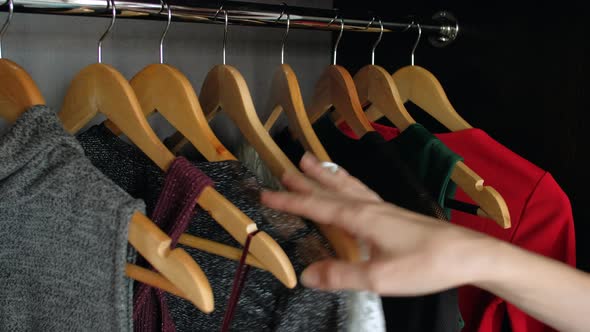 Woman Hand Choosing Dress in Wardrobe for Evening Dinner or Party