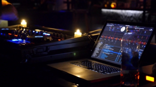 Dj Mixing Tracks In Nightclub At Party