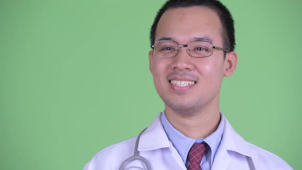 Face of Happy Asian Man Doctor with Eyeglasses Thinking