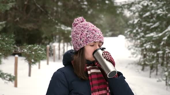 Young Woman Walking in the Winter Park