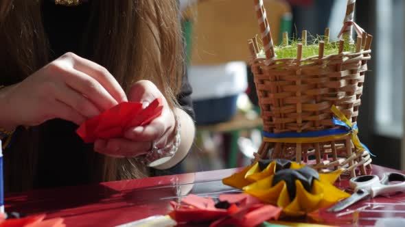 Girl Uses Glue And Makes Red Flower From Paper