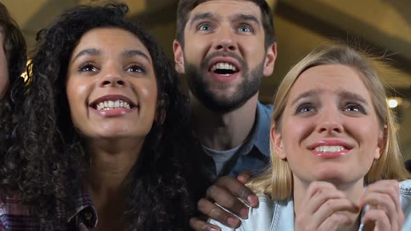 Group of Fans Emotionally Cheering for Favorite Football Team Victory in Pub