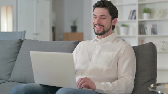 Man Doing Video Chat on Laptop at Home