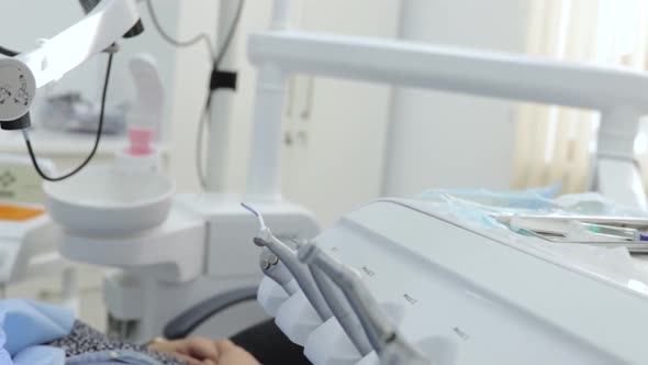 Dentist treating teeth to patient with Dental equipment