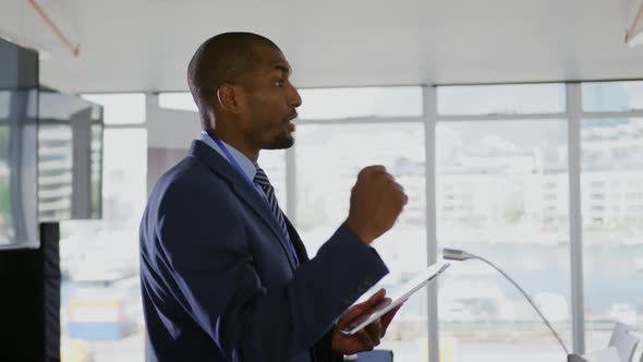 Male speaker addressing the audience at a business conference