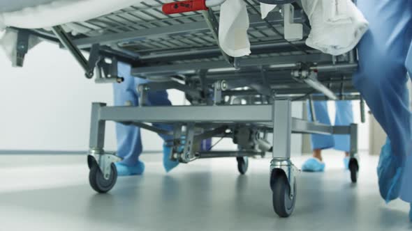 Feet of staff moving hospital bed in an emergency 4k