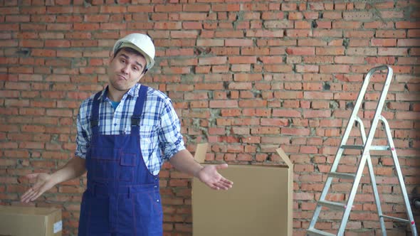 Perplexed and Confused Man in Working Uniform Waving His Arms