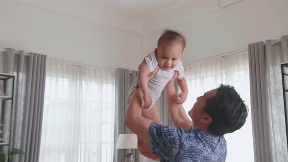 Asian Father And Son Playing In Home