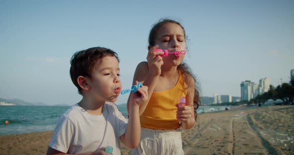 Happy Children Playing with Soap Bubbles