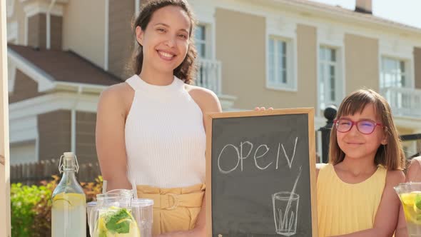 Mom And Daughters Selling Lemonade Outdoors