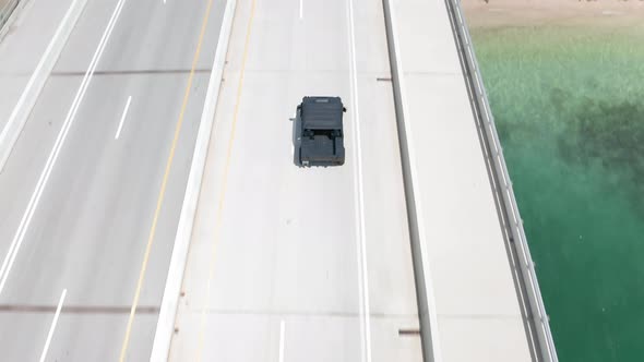  Aerial View of Hammer Vehicle Driving By Bay Bridge Over Miami Harbor Florida