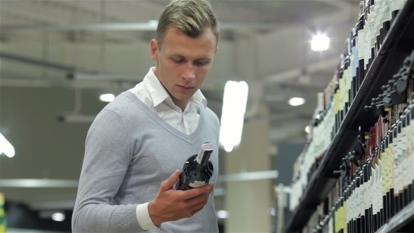 Handsome Looking At Wine Bottle