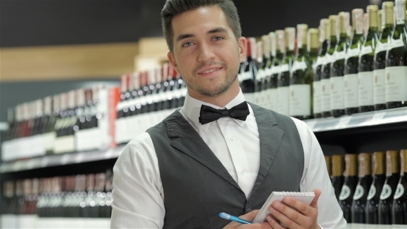 Side View Of Confident Young Sommelier