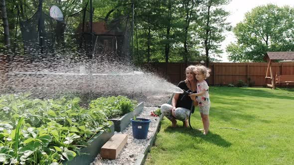 Mom and Daughter to Spray Plants with Water Working Together Agriculture Care 