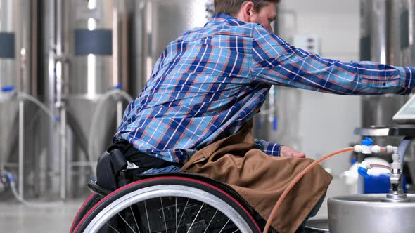 Person with Disability Who Uses a Wheelchair Working at Craft Beer Factory