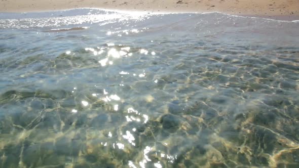 Transparent Sea Water In Shallow  Glare From Sun