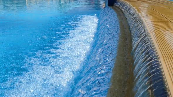 Water Splashing Down Into A Pool