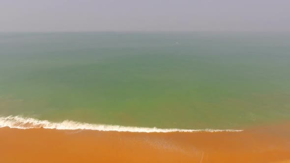 Flying Up Over Sand Beach And Sea Waves