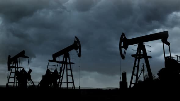 Working Oil Pumps Silhouette Against The Background Of The Dark Storm Clouds 1