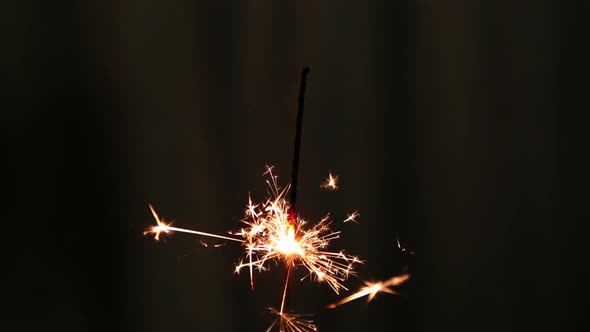 Sparkler Burning On Dark Background alt