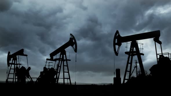 Working Oil Pumps Silhouette Against The Background Of The Dark Storm Clouds 2 alt