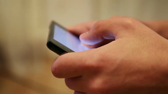 Man's Hands Printing Text On Smartphone 1