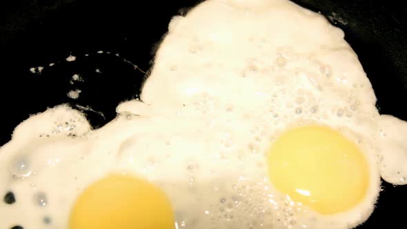 Fried Egg On Black Pan -